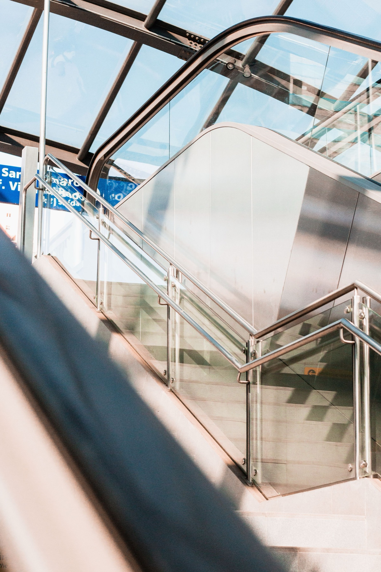 Grey glass and stainless handrail on a commercial stair